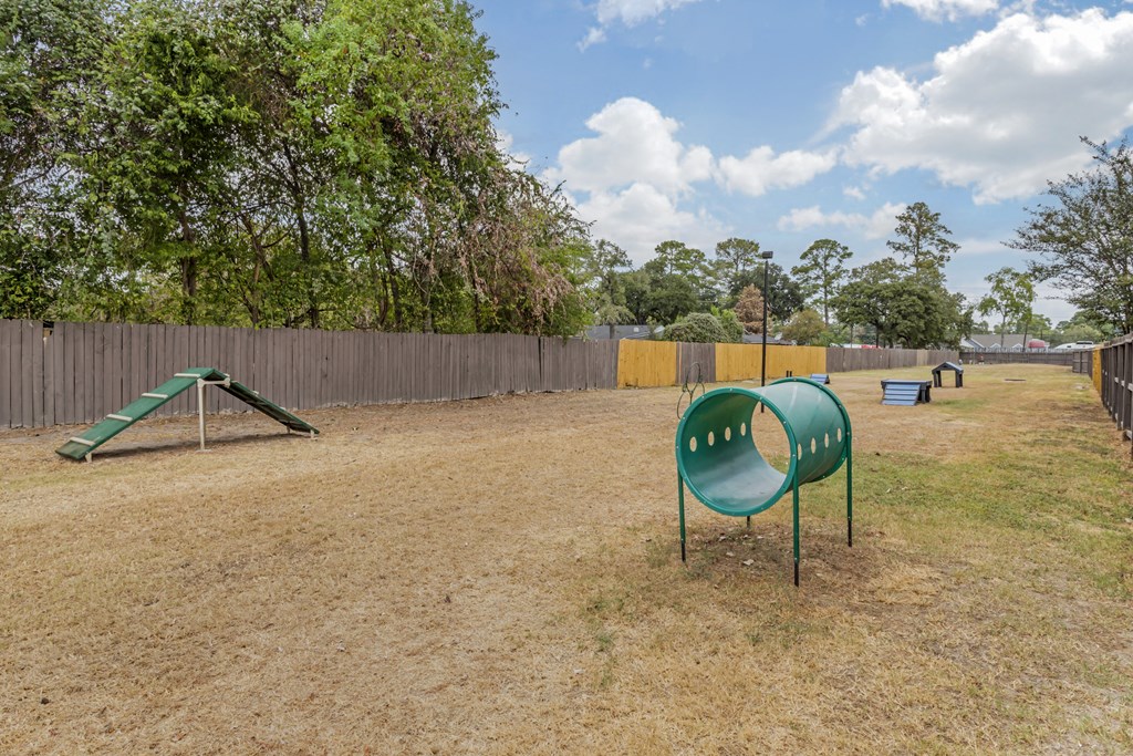 a park with a green playground and a slide