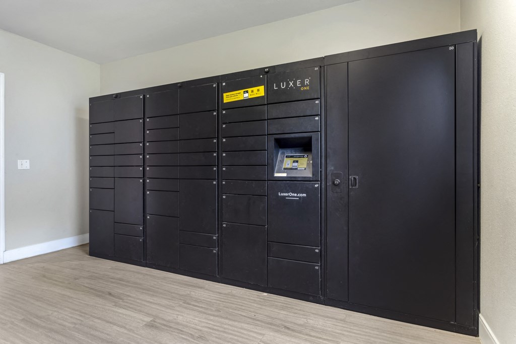 a large set of black lockers in the corner of a room