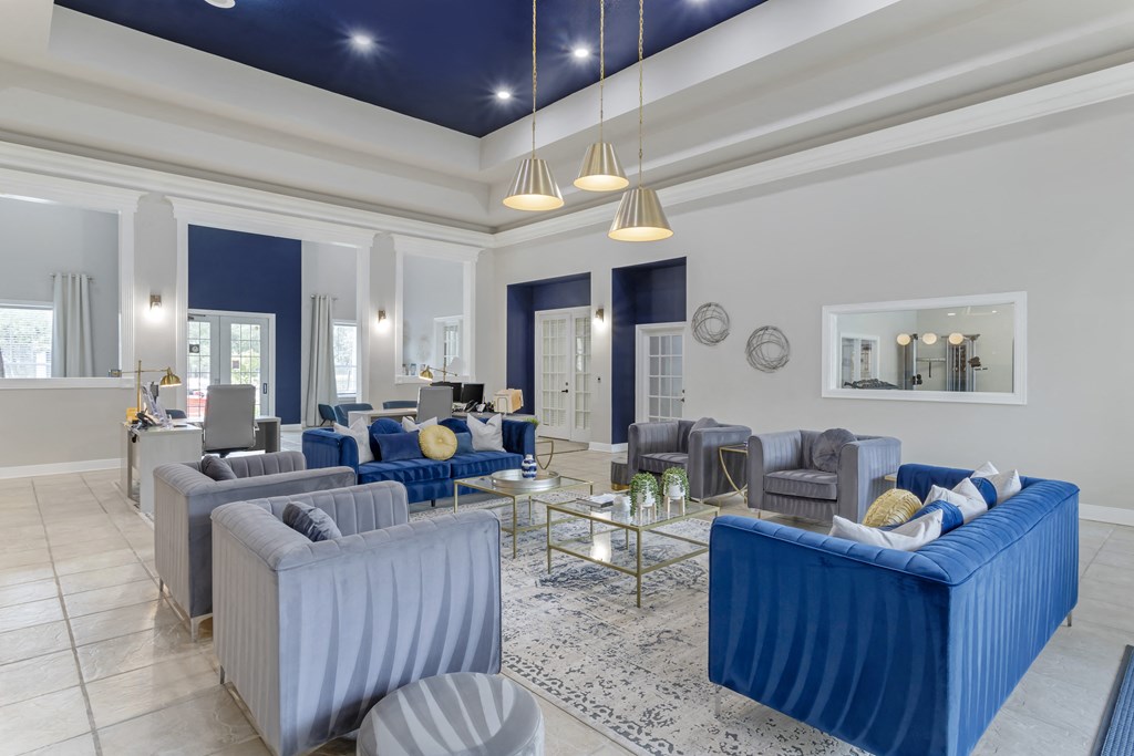 a living room with blue couches and chairs