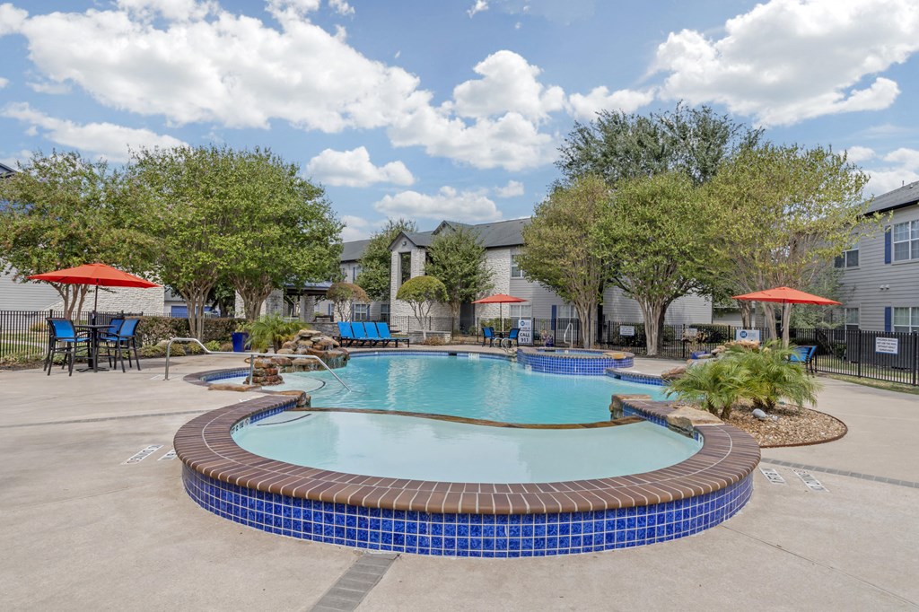 the preserve at ballantyne commons community swimming pool with trees and apartment buildings