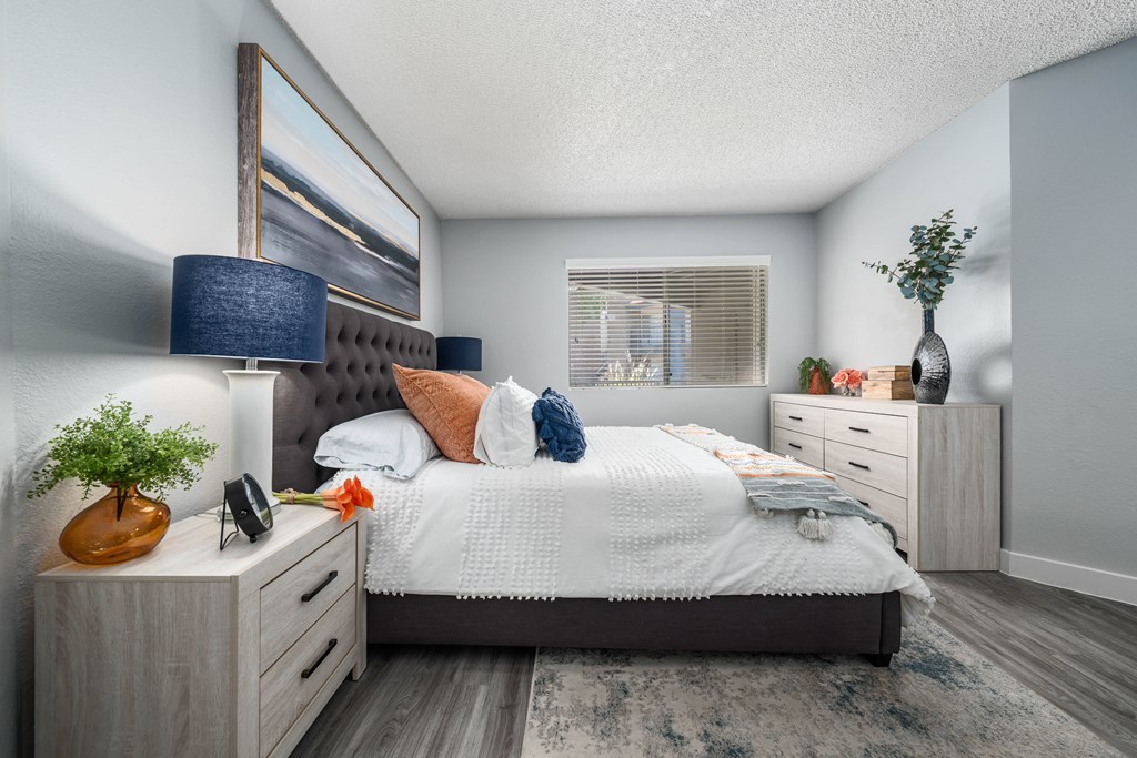 a bedroom with a bed and two dressers