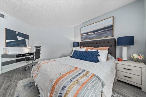 a bedroom with a bed and desk in a 555 waverly unit