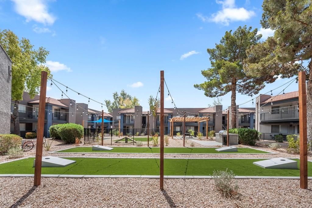 a park with swings and agility courses at the whispering winds apartments in pearland, tx