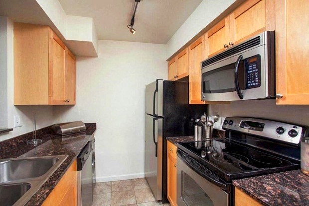 a kitchen with stainless steel appliances and wooden cabinets