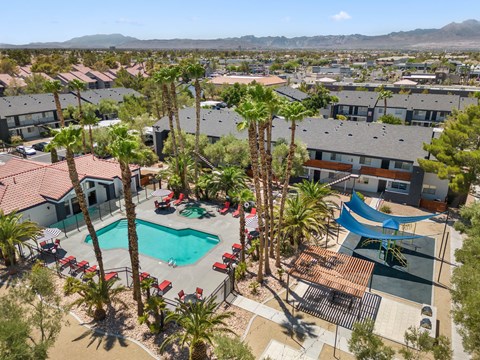 an aerial view of a resort style pool with a slide
