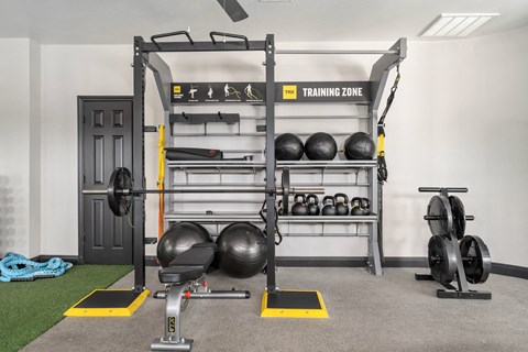 a home gym with a lifting rack and weights