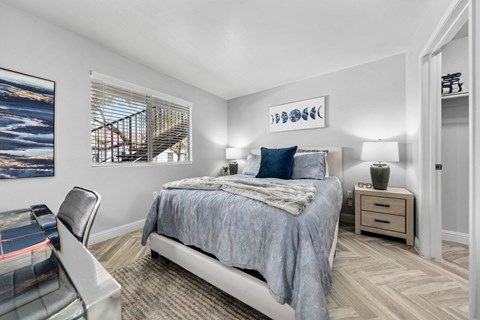 a bedroom with a bed and a desk