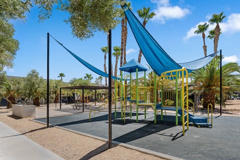 a playground with a hammock in the middle of it