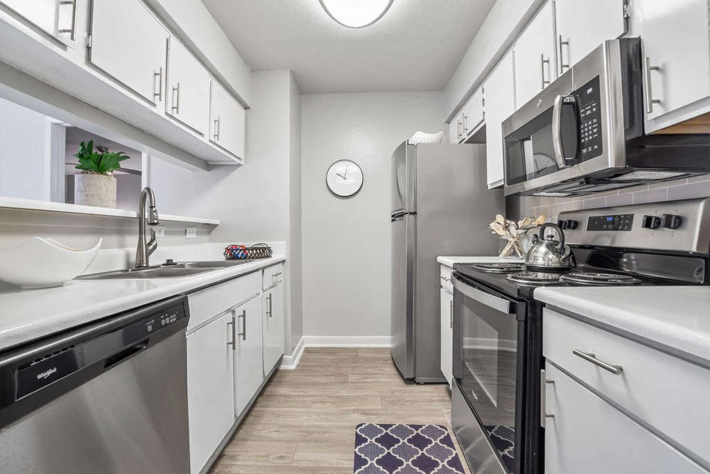 a kitchen with stainless steel appliances and white cabinets