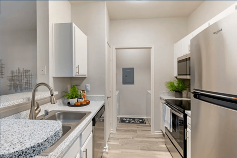 A modern kitchen with stainless steel appliances and a granite countertop.