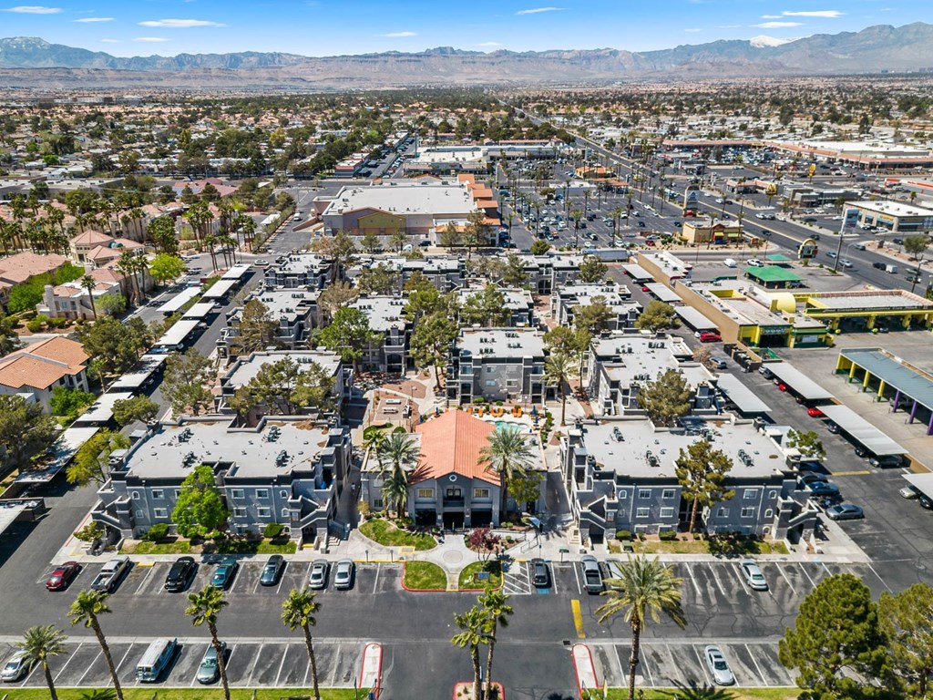 an aerial view of a city with mountains in the background