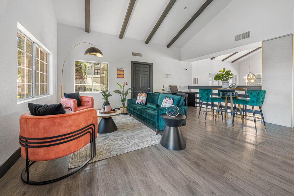 a living room with white walls and hardwood floors