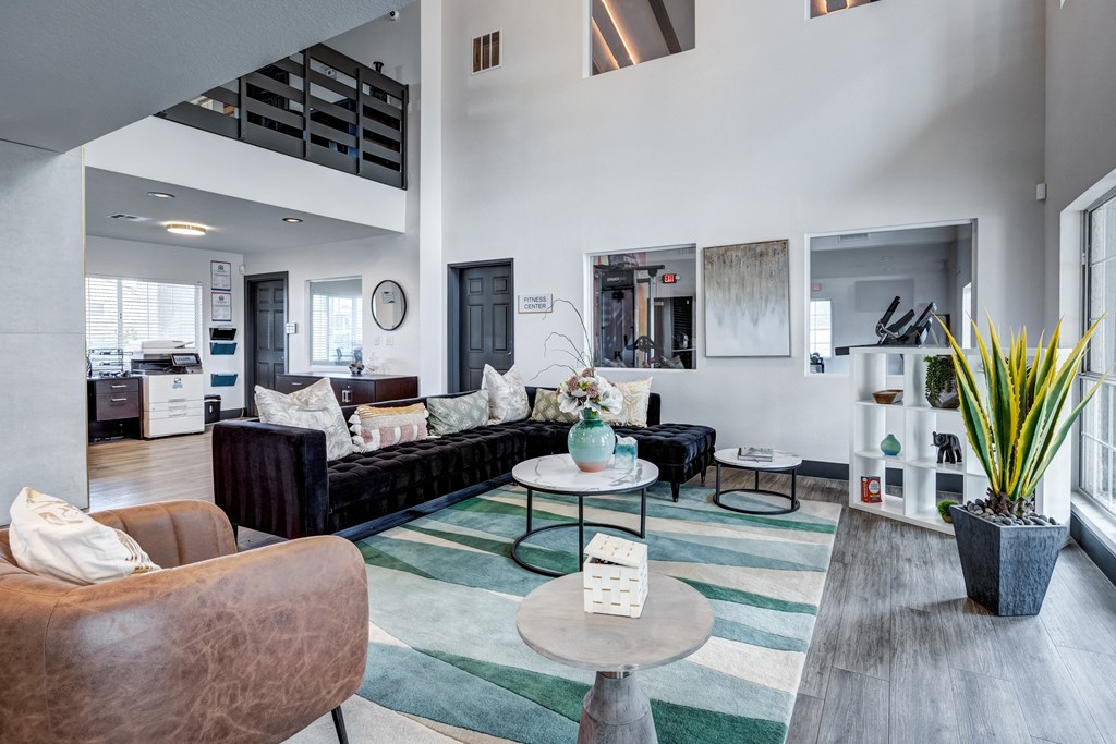 a living room with couches and chairs and a rug