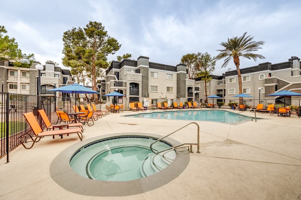 our apartments have a resort style pool with chairs and umbrellas