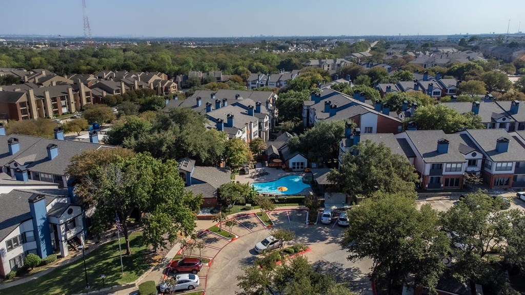 a aerial view of a neighborhood with houses and a swimming pool