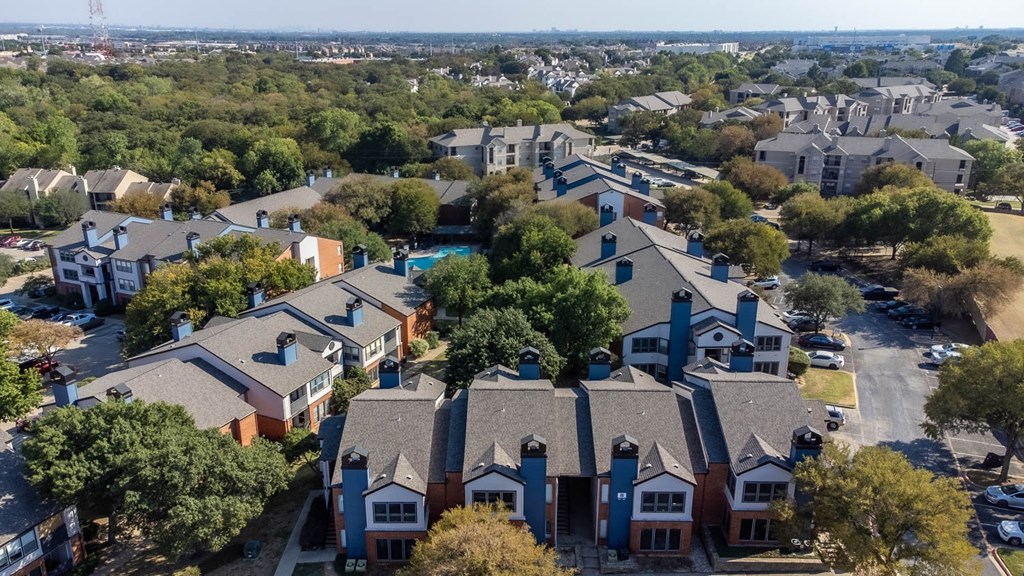 an aerial view of a neighborhood with houses and a swimming pool