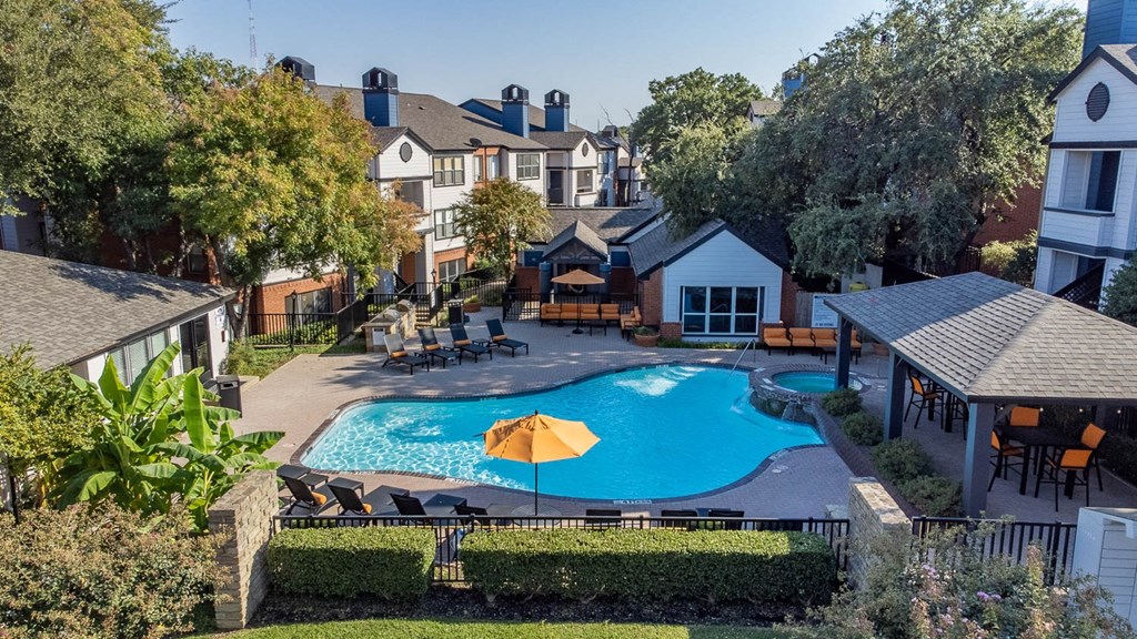 a backyard with a swimming pool and a house