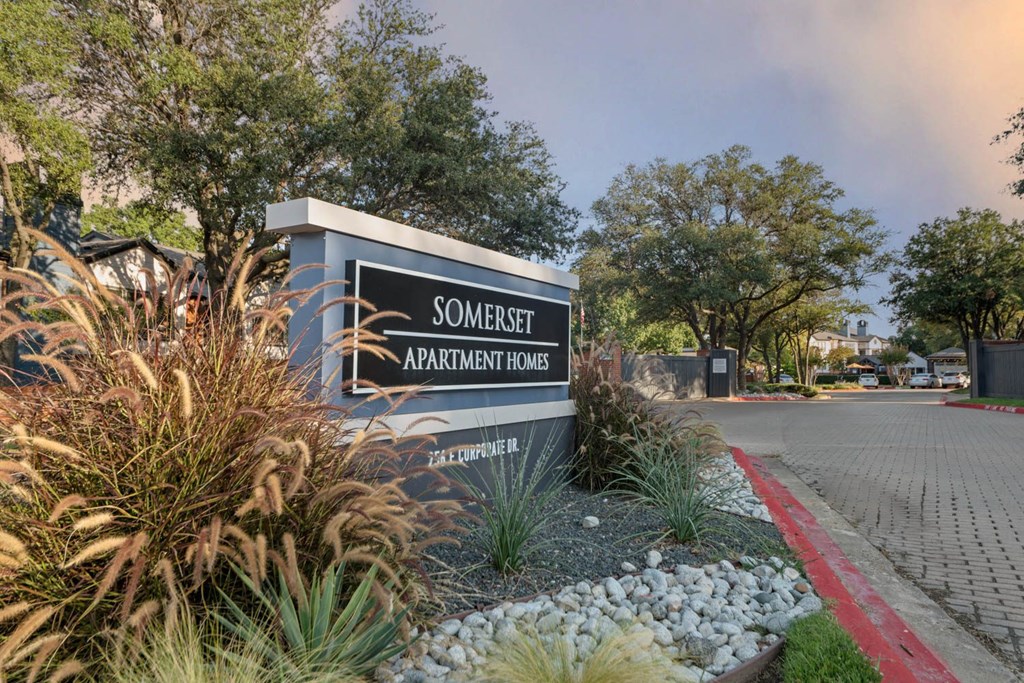 a sign for somerset apartments at the entrance of the street