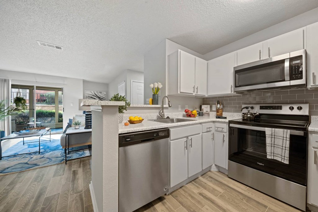 a kitchen with stainless steel appliances and white cabinets