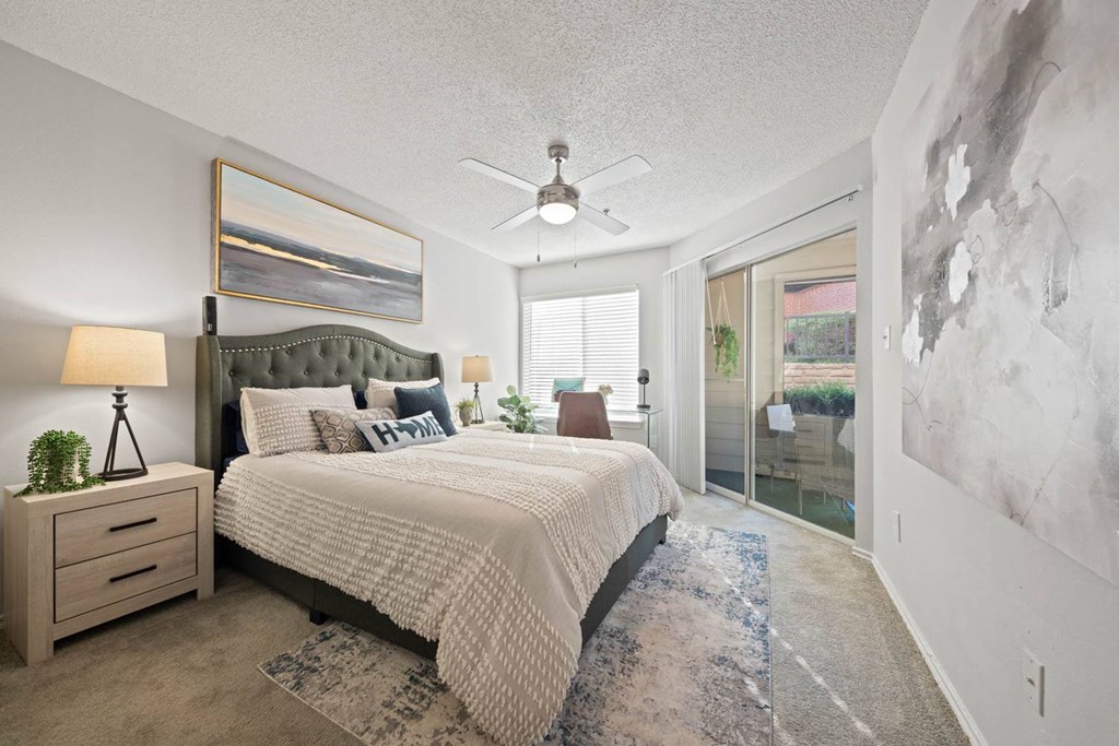 a bedroom with a bed and a ceiling fan