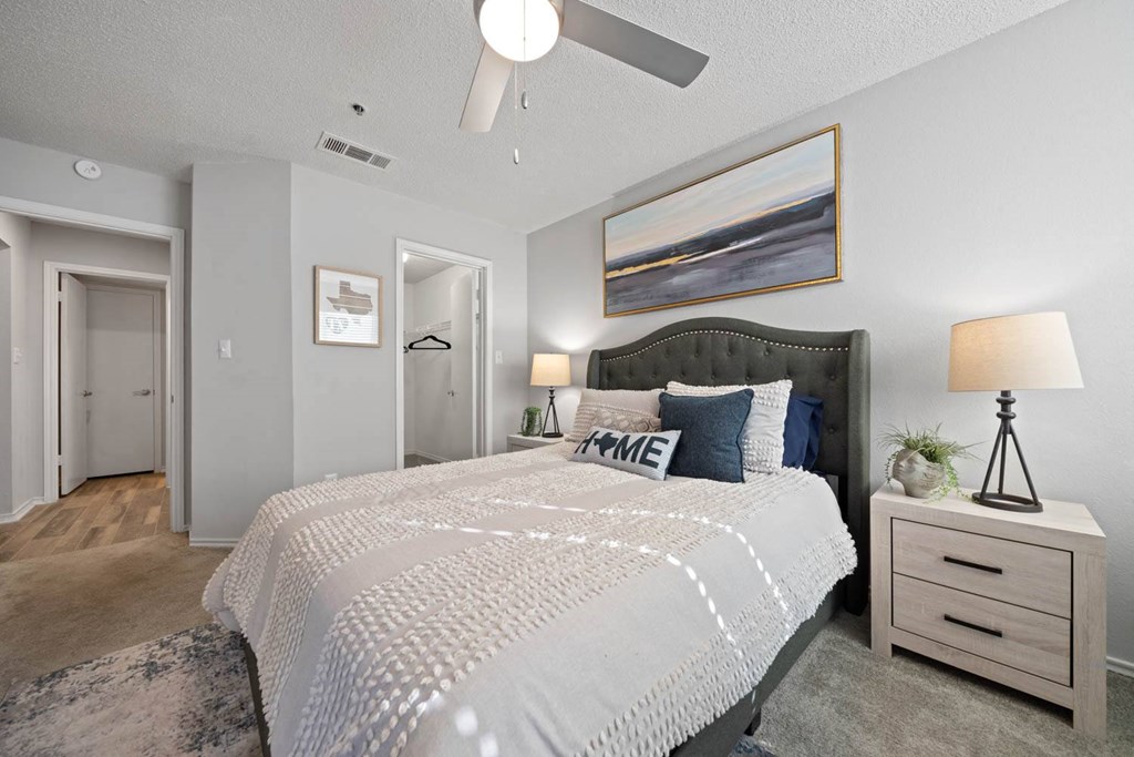 a bedroom with a bed and a ceiling fan