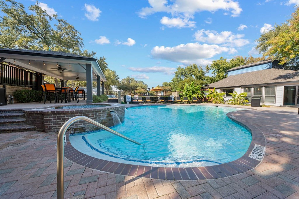 a swimming pool with a house in the background