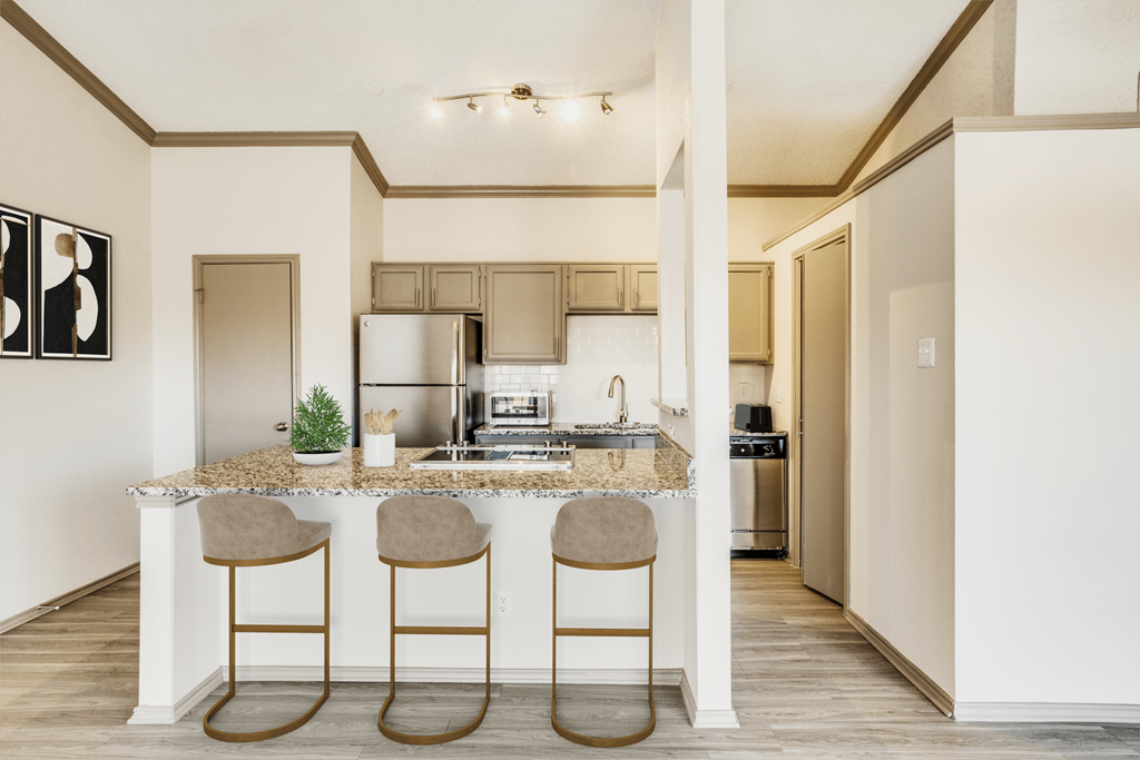 a kitchen with a marble counter top and three stools