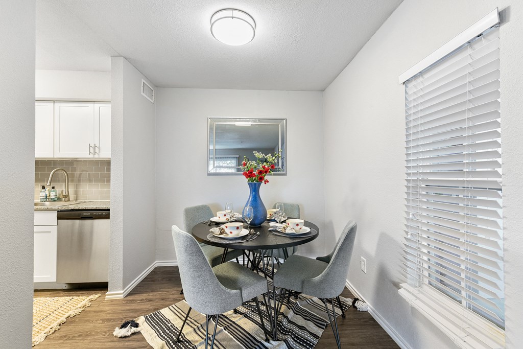 a dining room with a table and chairs and a kitchen