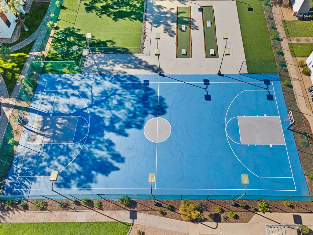 Sports court with basketball and cornhole
