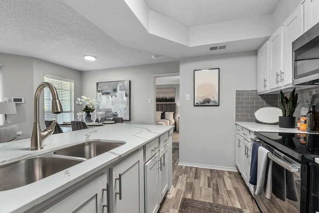 a kitchen with a sink and a stove