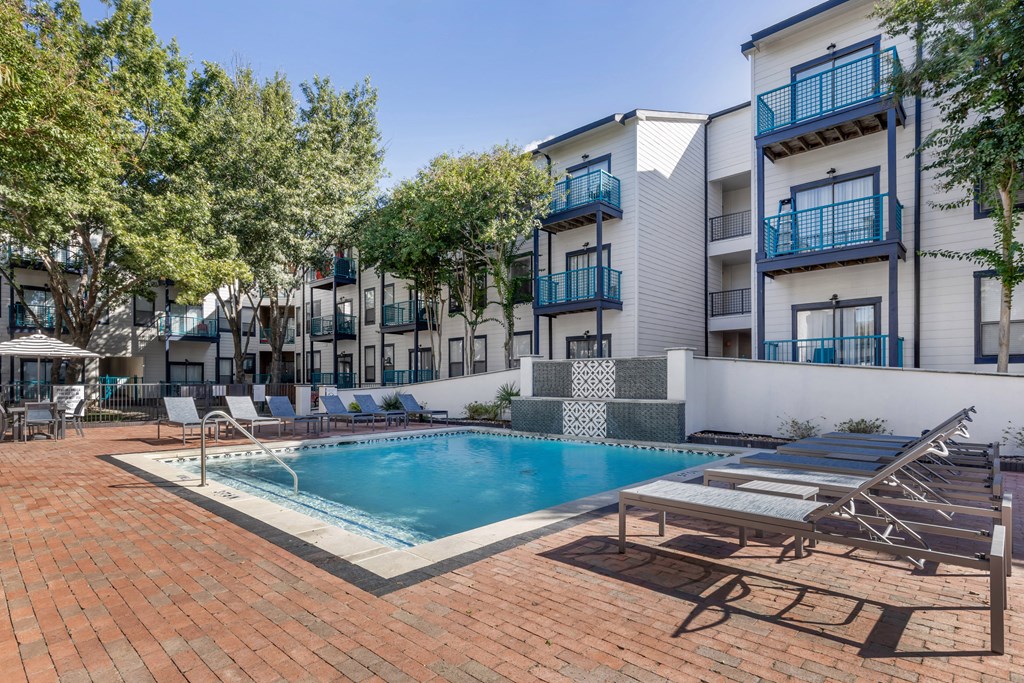 a swimming pool in front of an apartment building