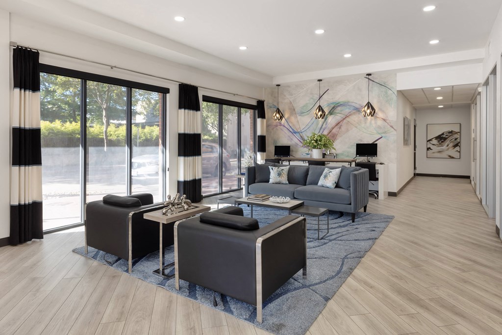 a living room with couches and chairs and a rug