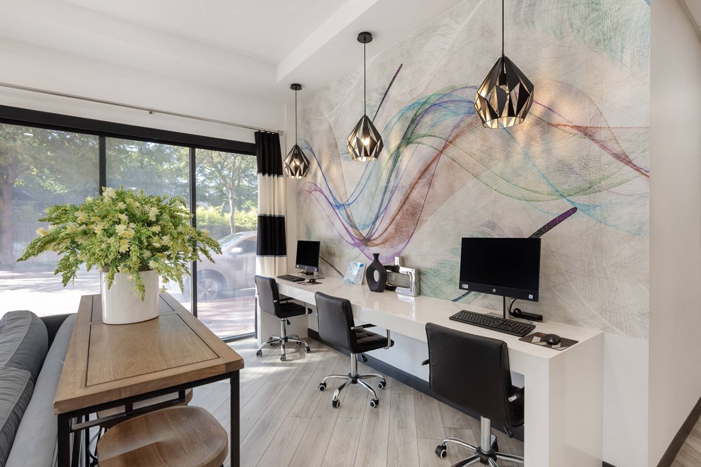 a home office with a white desk and a large window