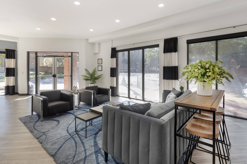 a living room with a couch and chairs and a table