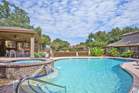 a swimming pool with a patio and a house with a pool