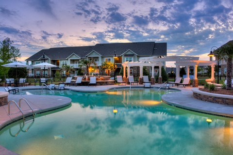 A large house with a pool in front of it.