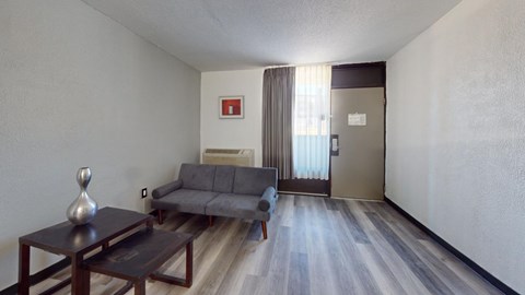 A living room with a grey couch and a coffee table.