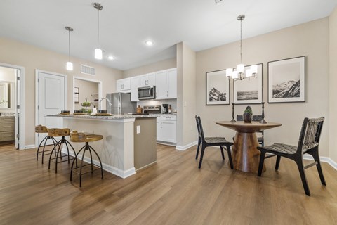 an open kitchen and dining room with a table and chairs