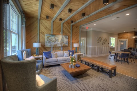 A living room with a grey couch and a wooden coffee table.