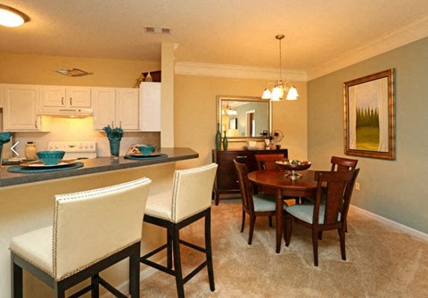 a kitchen and dining room with a table and chairs