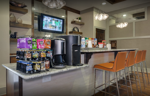 A kitchen counter with a variety of snacks and drinks on it.