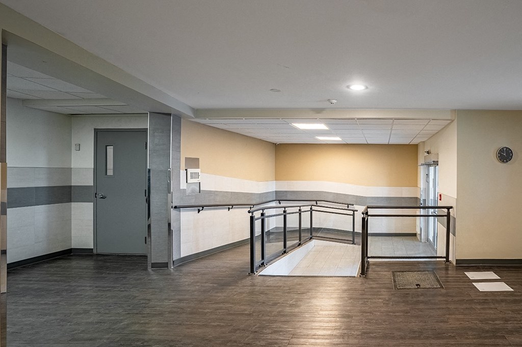 a large room with wood floors and beige walls