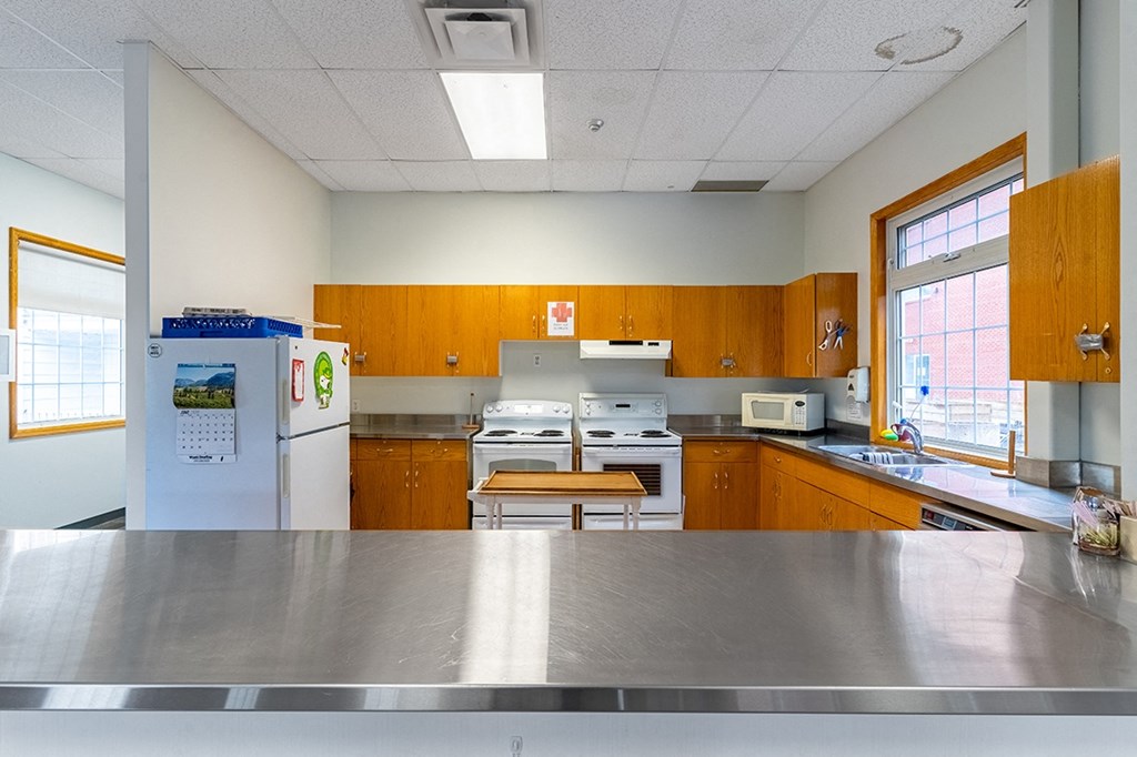 a kitchen with white appliances and wood cabinets