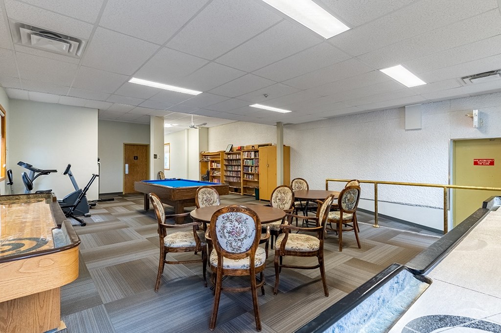 a recreation room with a pool table and shuffleboard