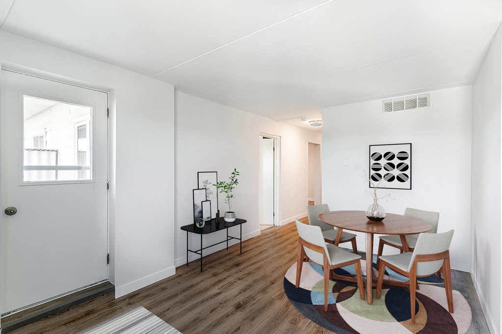 a dining room with a wooden table and chairs