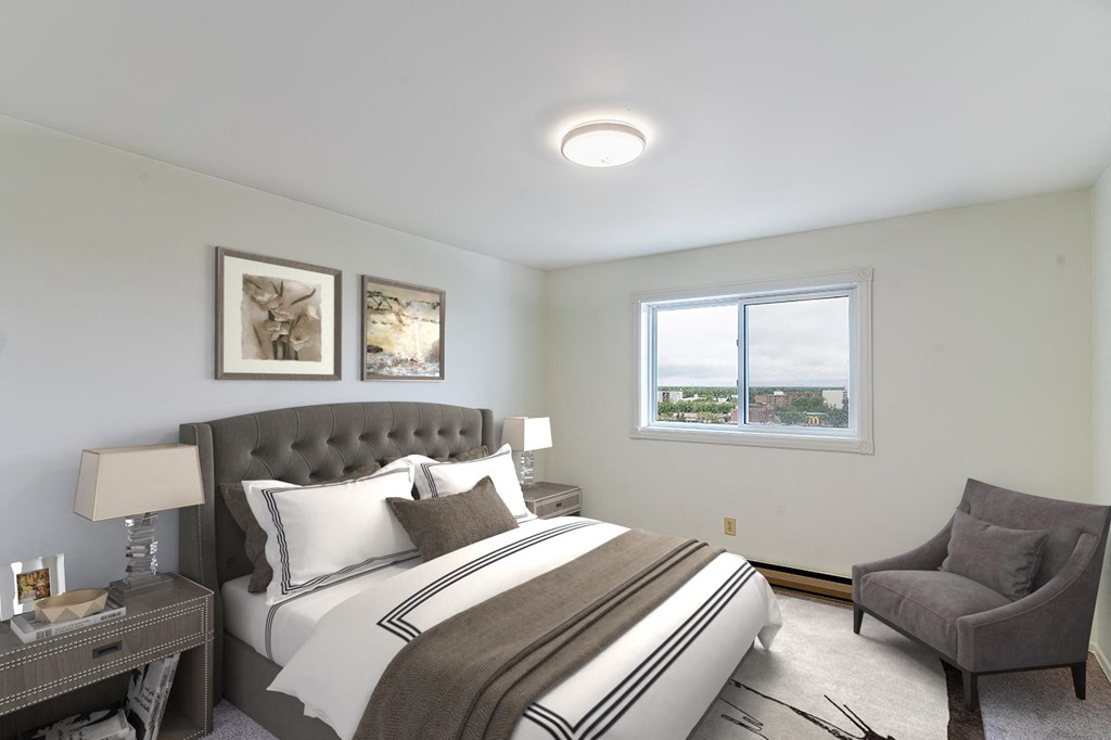 a bedroom with a bed and a chair in a room