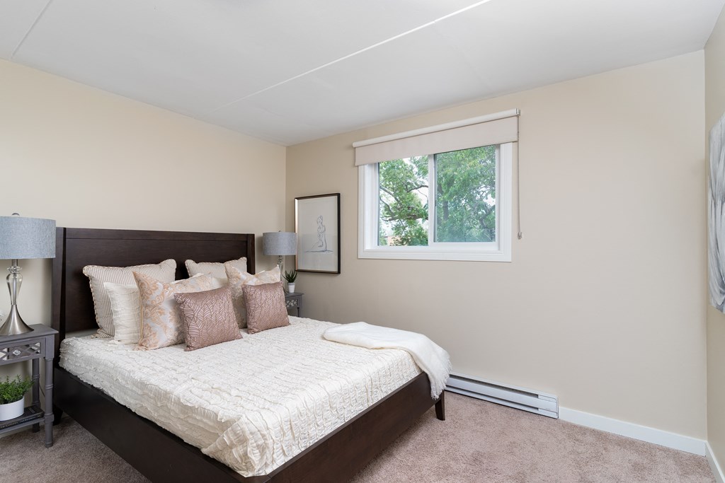 a bedroom with a bed and a window