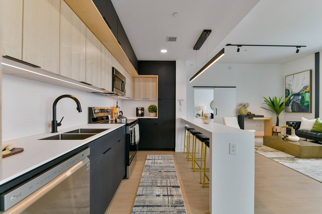 a kitchen with a long counter top and a sink