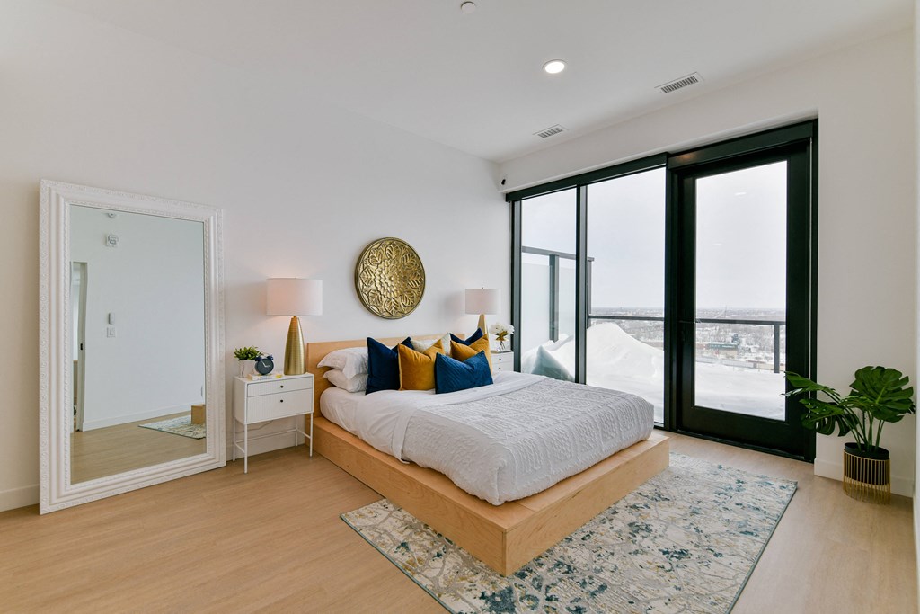 a bedroom with a large bed and a large window