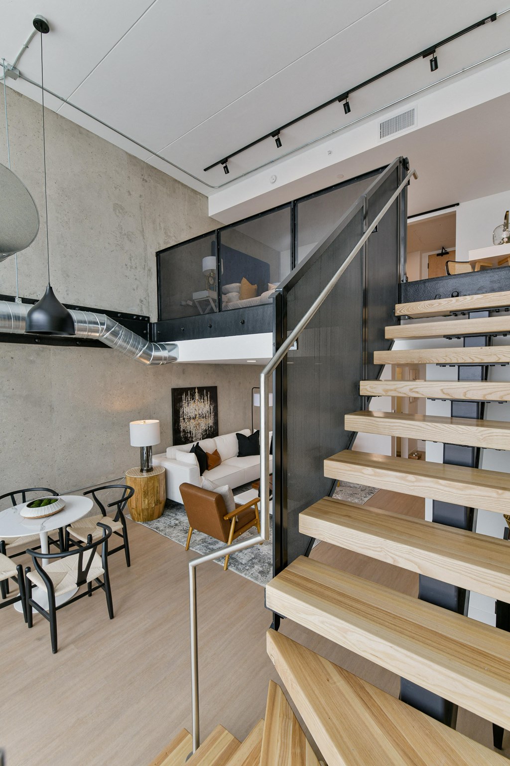 a staircase leading up to a living room with a couch and a table